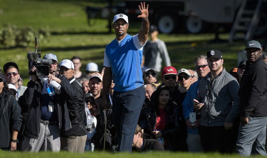 SAN DIEGO, CA - JANUARY 26: Tiger Woods stops fans from moving before playing his chip shot on the first hole during the first round of the Farmers Insurance Open at Torrey Pines Golf Course on January 26, 2017 in San Diego, California. (Photo by Stan Badz/PGA TOUR)