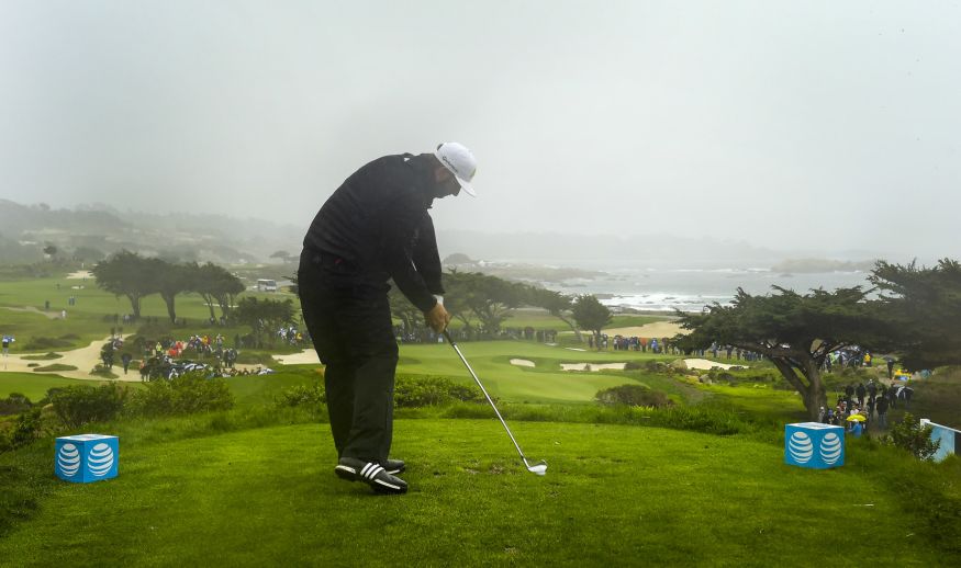 PEBBLE BEACH, CA - FEBRUARY 09: Dustin Johnson plays a tee shot into the rain on the 11th hole during the first round of the AT&T Pebble Beach Pro-Am at Pebble Beach Golf Links, Spyglass Hill Golf Course, Monterey Peninsula Country Club (Shore Course) on February 9, 2017 in Pebble Beach, California. (Photo by Stan Badz/PGA TOUR)