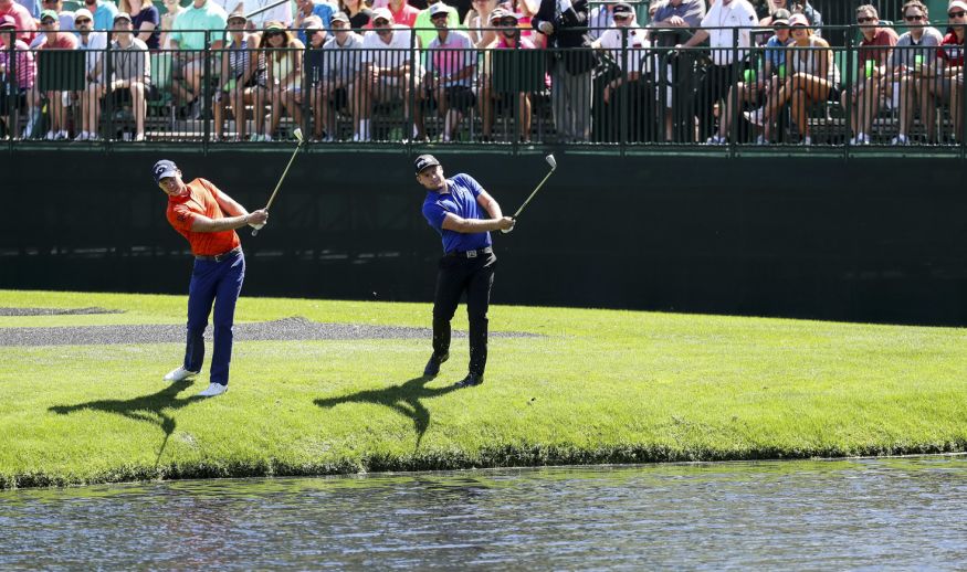 AUGUSTA, GA - APRIL 04:  (L-R) Danny Willett of England and Tyrrell Hatton of England successfully skip their golf balls accross the water to the green on the 16th hole during a practice round prior to the start of the 2017 Masters Tournament at Augusta National Golf Club on April 4, 2017 in Augusta, Georgia.  (Photo by Rob Carr/Getty Images)