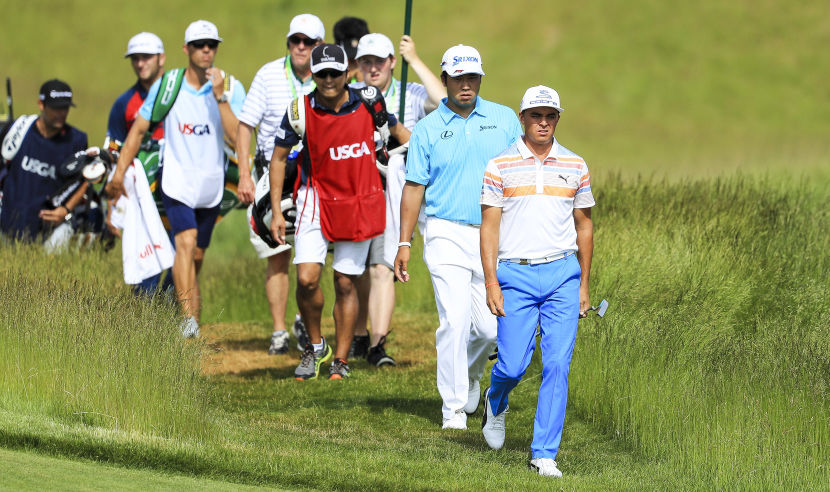 HARTFORD, WI - JUNE 15:  Hideki Matsuyama of Japan (L) and Rickie Fowler of the United States walk across the 16th hole during the first round of the 2017 U.S. Open at Erin Hills on June 15, 2017 in Hartford, Wisconsin.  (Photo by Richard Heathcote/Getty Images)