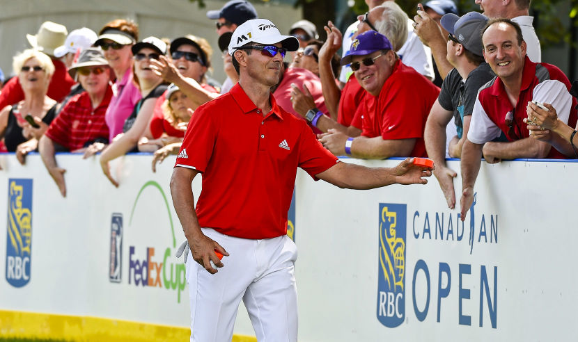 OAKVILLE, ON - JULY 28:  Mike Weir of Canada hands out hockey pucks to fans on the seventh tee during the second round of the RBC Canadian Open at Glen Abbey Golf Club on July 28, 2017 in Oakville, Canada.  (Photo by Minas Panagiotakis/Getty Images)