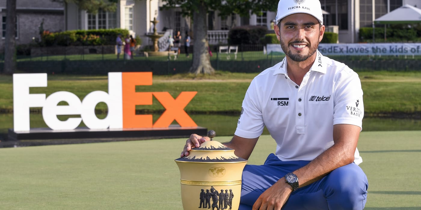 Abraham Ancer poses with the WGC trophy